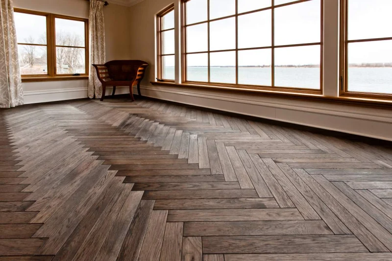 A spacious living room with a herringbone Parquet floor