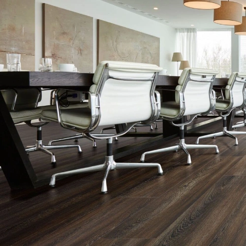 Commercial PVC flooring in a dark wood grain.