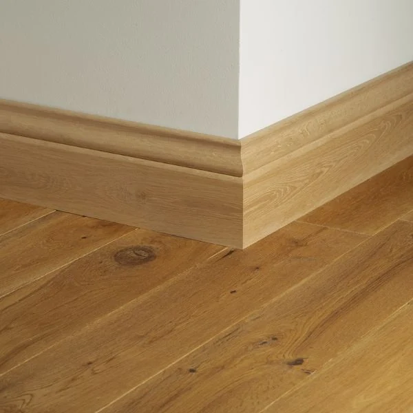 Light wooden skirting on oak floor