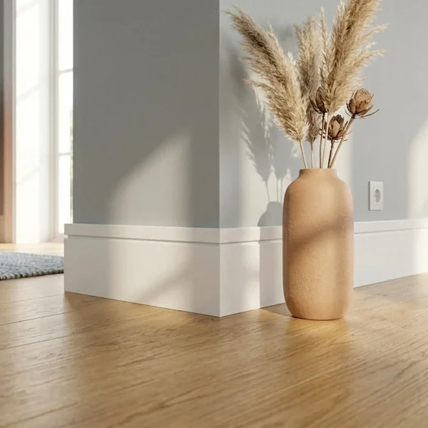 White skirting board beside vase decor.