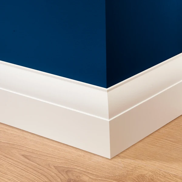 White skirting board on blue wall