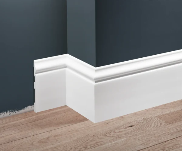 White skirting board on dark wall