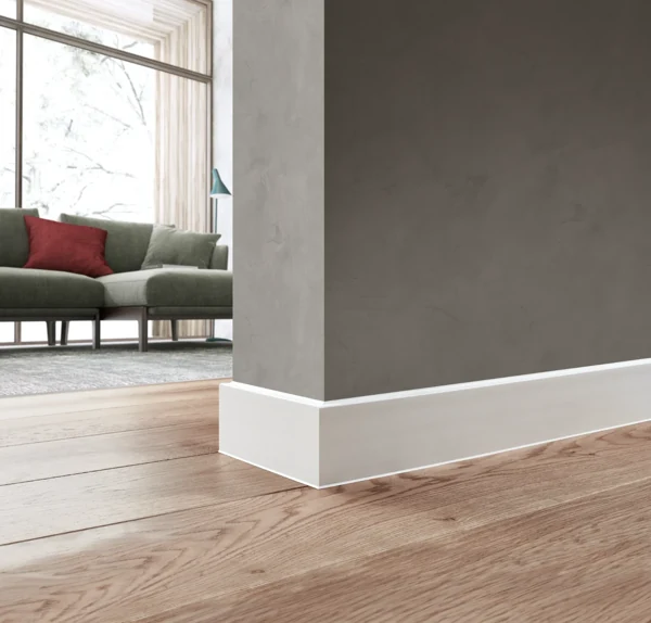 White skirting board on wood floor.